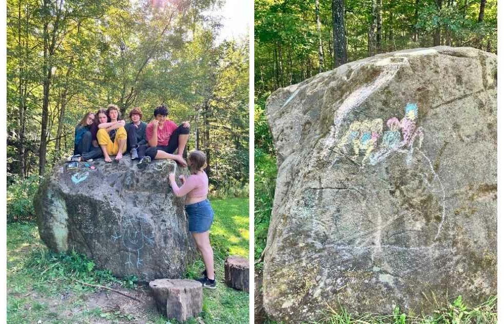 Campers sitting on their favorite rock, Carl.