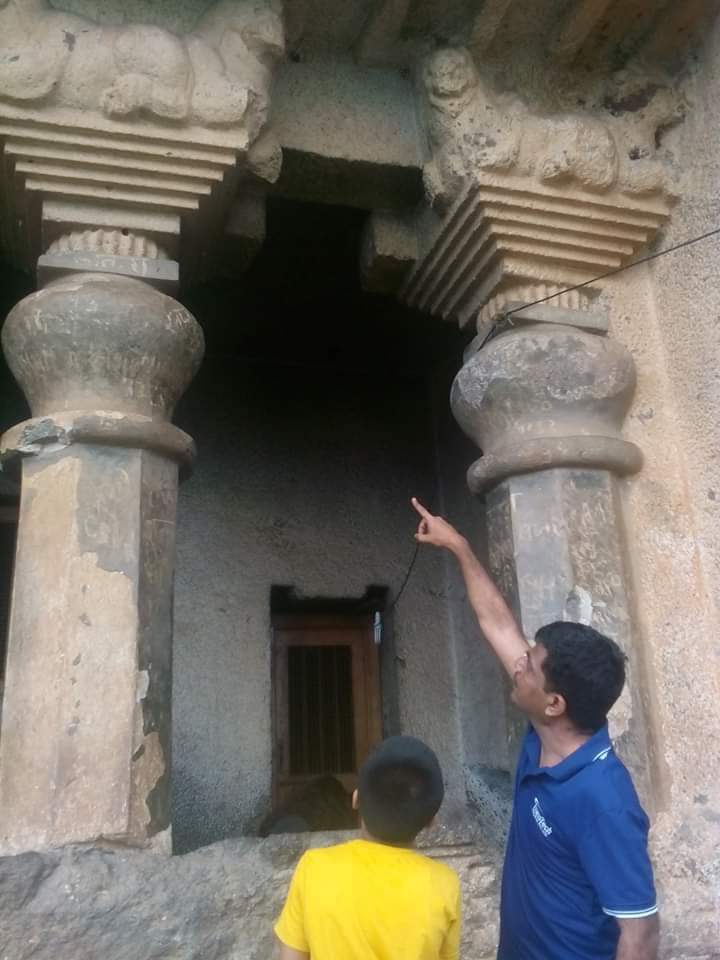 Photo of author with his dad who's pointing up at some columns on an ancient building